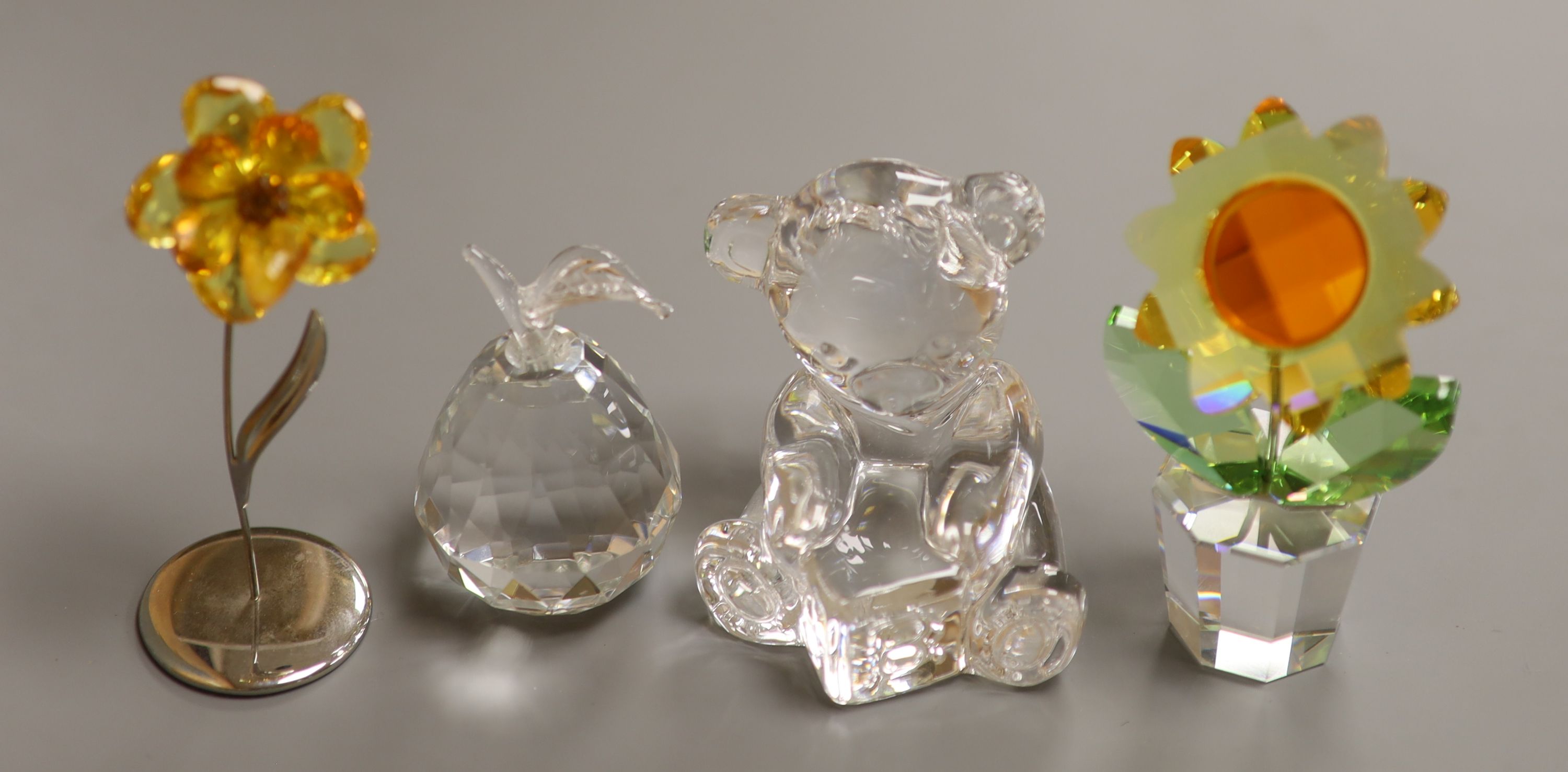 A Swarovski 'Sunflower', with topaz centre and yellow petals in clear glass pot (boxed), a smaller yellow flower and a Waterford crystal teddy bear